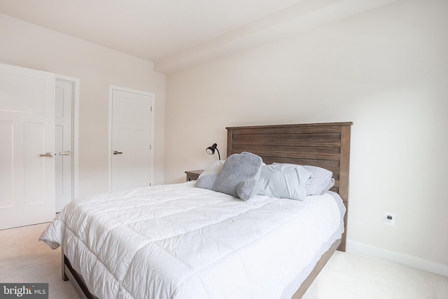 bedroom with light colored carpet