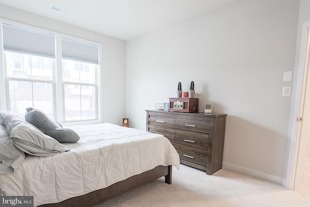 bedroom with light colored carpet