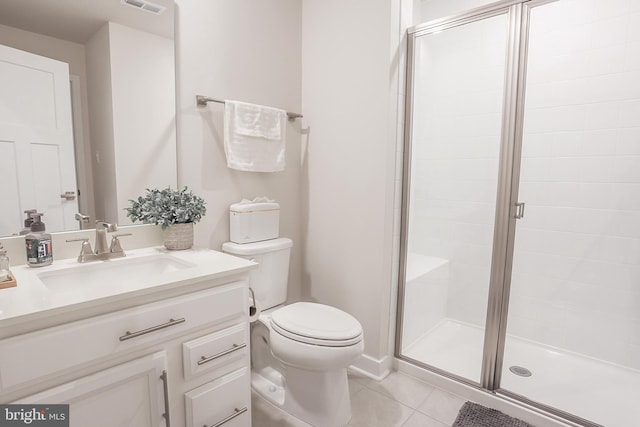 bathroom with vanity, toilet, tile patterned floors, and walk in shower