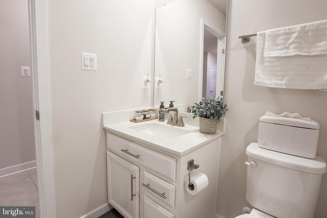 bathroom with vanity, toilet, and tile patterned flooring