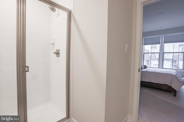 bathroom featuring a shower with door