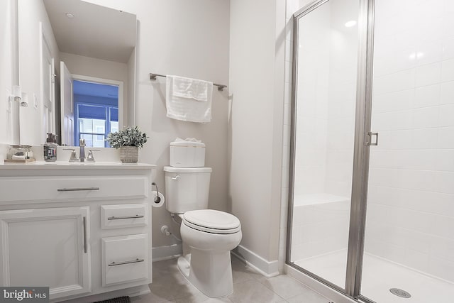 bathroom featuring tile patterned floors, vanity, toilet, and a shower with shower door