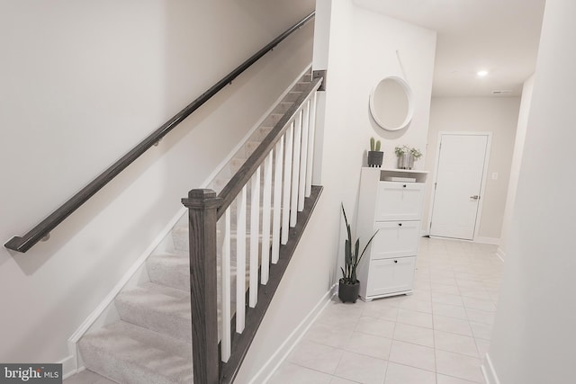 stairs featuring tile patterned flooring