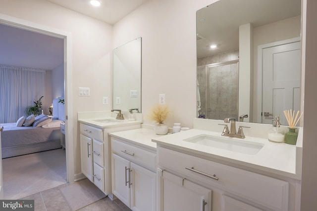 bathroom featuring tile patterned flooring, vanity, and walk in shower