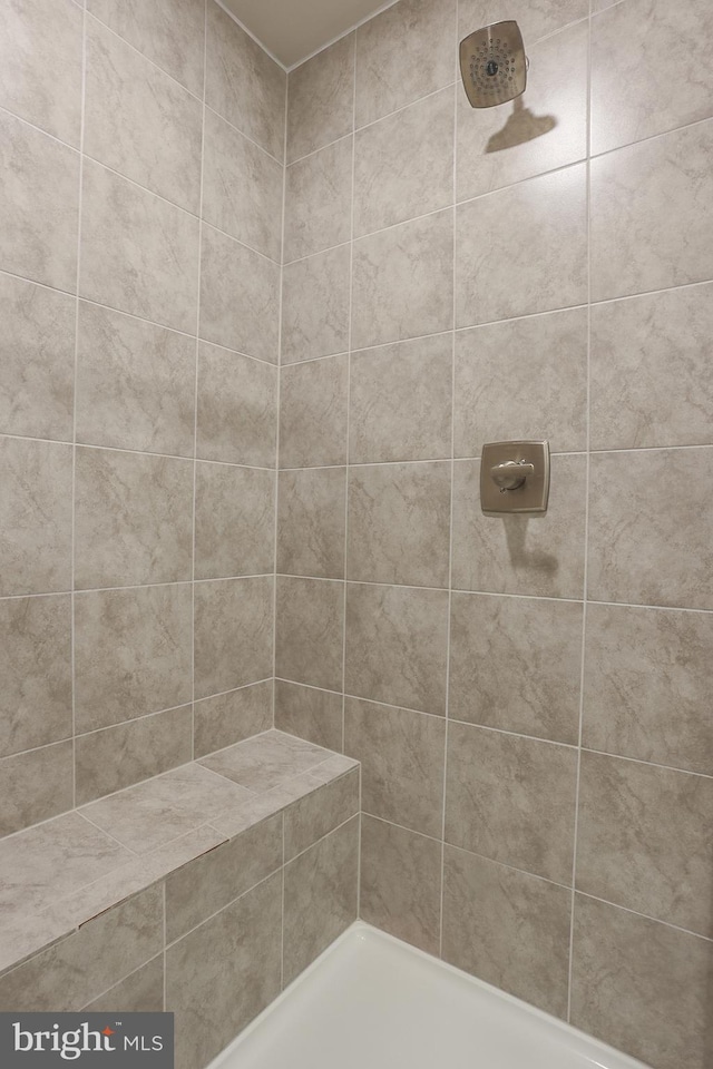 bathroom with a tile shower