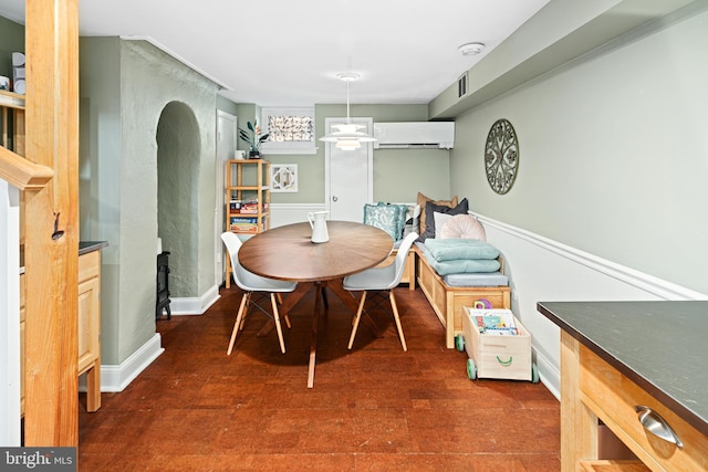 dining room featuring a wall mounted AC