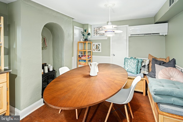 dining space featuring a wall mounted air conditioner