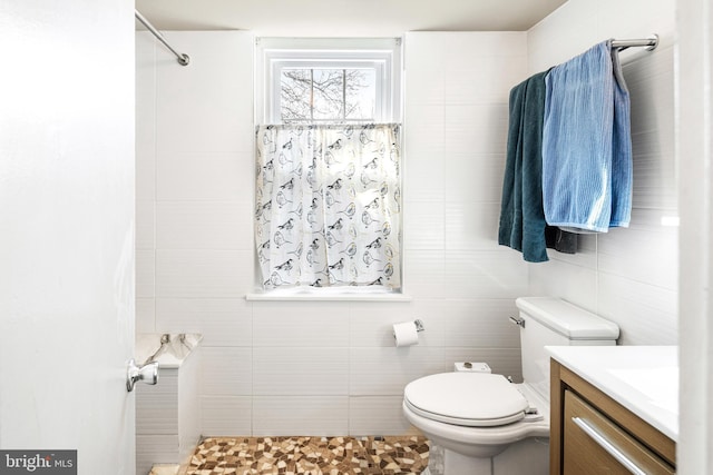 bathroom featuring a shower, toilet, and vanity