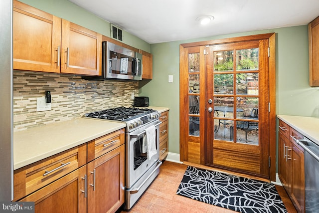 kitchen featuring appliances with stainless steel finishes and tasteful backsplash