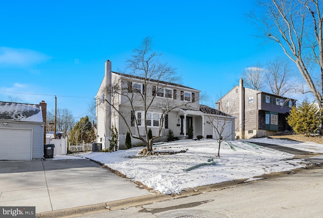 view of front of house featuring a garage and cooling unit