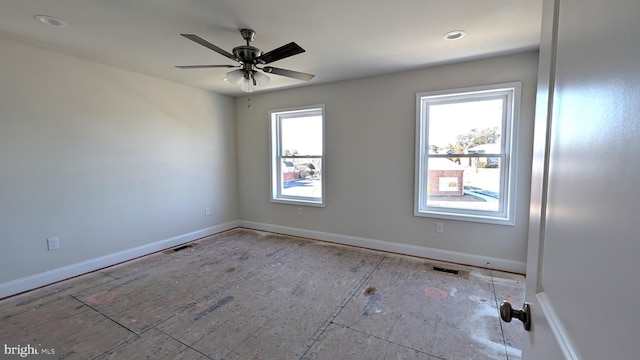 empty room featuring ceiling fan and a healthy amount of sunlight