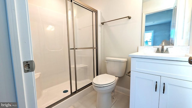 bathroom with tile patterned flooring, vanity, toilet, and an enclosed shower