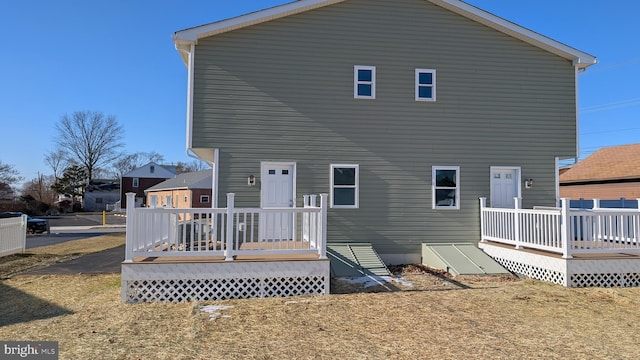 rear view of property with a wooden deck