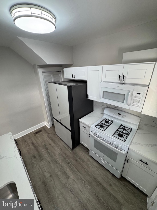 kitchen featuring light stone countertops, dark hardwood / wood-style flooring, white appliances, and white cabinetry