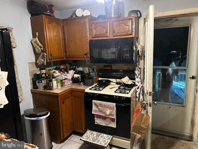 kitchen featuring light tile patterned floors and range with gas stovetop