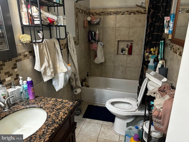 full bathroom featuring tile patterned floors, toilet, shower / bath combo with shower curtain, vanity, and tile walls