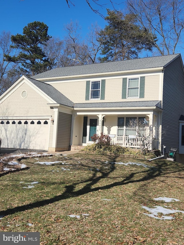 front facade with a porch, a front yard, and a garage