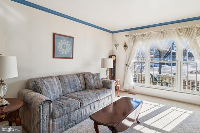 carpeted living room with ornamental molding