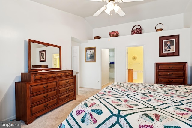 bedroom with lofted ceiling, ensuite bath, light carpet, and ceiling fan