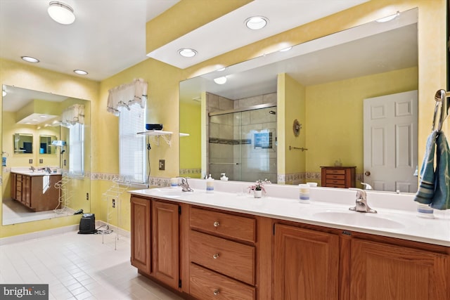 bathroom with walk in shower, vanity, and tile patterned floors