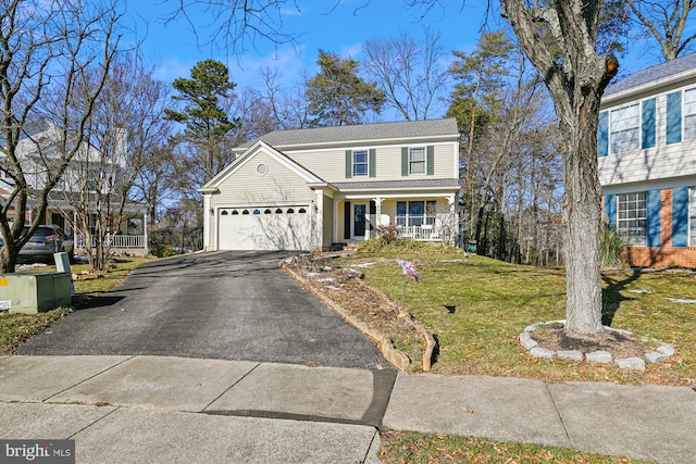 view of front property with a porch, a front yard, and a garage