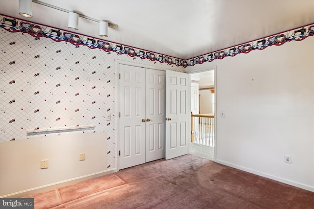 unfurnished bedroom with a closet and carpet floors