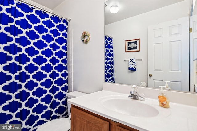 bathroom with toilet and vanity