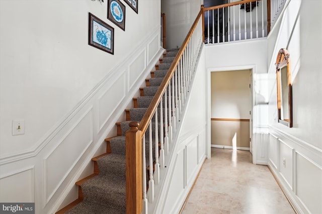 staircase with a towering ceiling