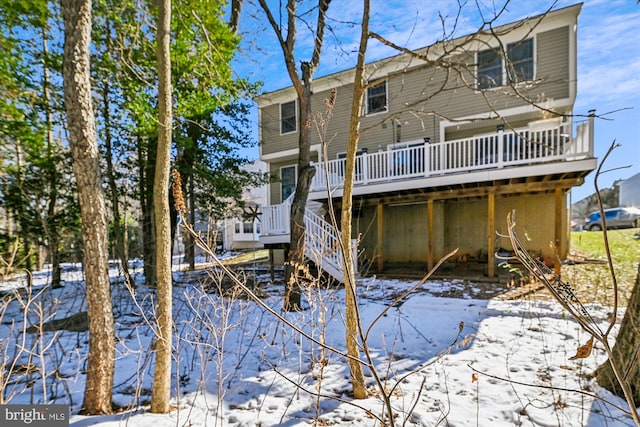 snow covered property with a deck