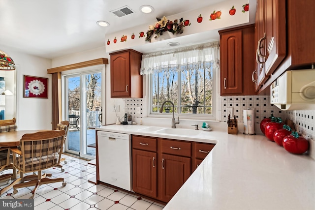 kitchen featuring sink, backsplash, and dishwasher