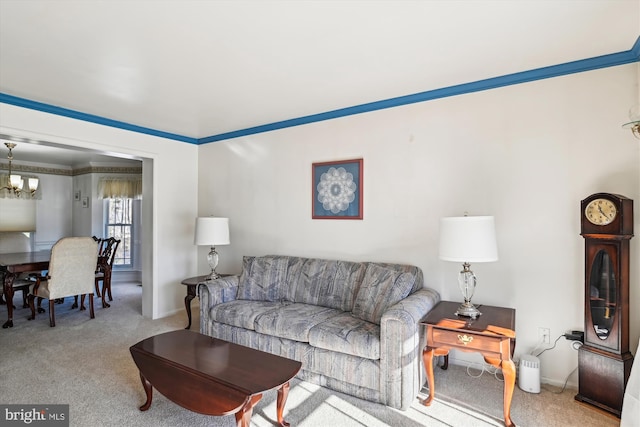 living room with ornamental molding, light colored carpet, and a chandelier