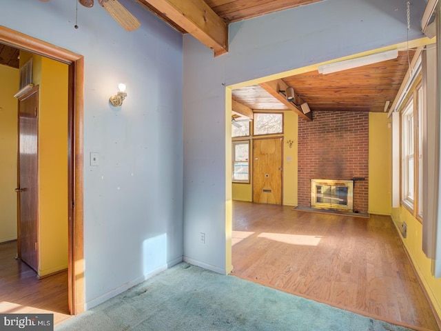 unfurnished living room with a fireplace, light hardwood / wood-style floors, vaulted ceiling with beams, ceiling fan, and wooden ceiling