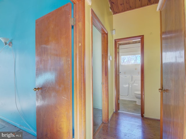 hallway featuring wood ceiling, hardwood / wood-style floors, and lofted ceiling