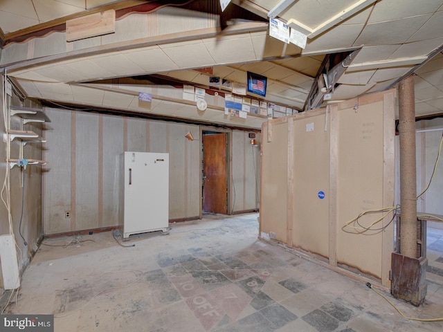 basement featuring white refrigerator