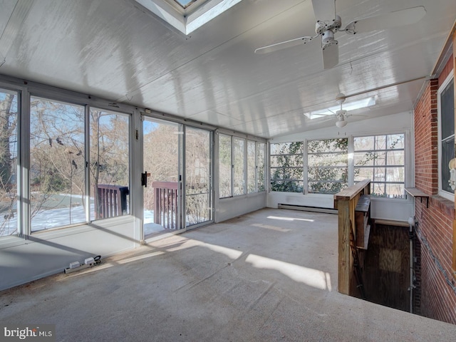 unfurnished sunroom with ceiling fan, lofted ceiling with skylight, a healthy amount of sunlight, and a baseboard radiator