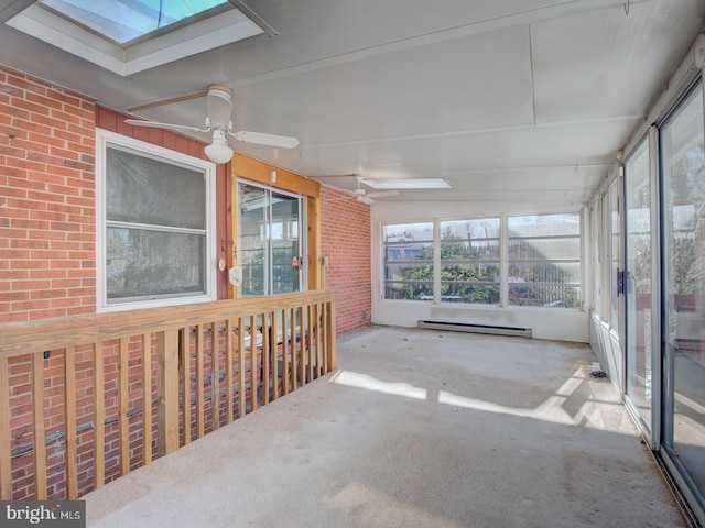 sunroom featuring ceiling fan, baseboard heating, and a skylight