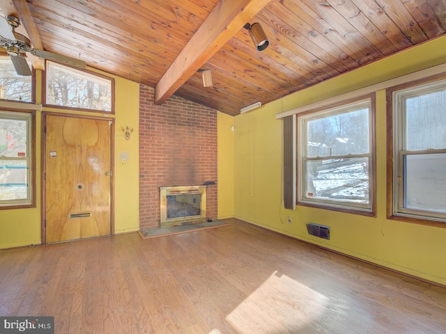 unfurnished living room featuring light hardwood / wood-style floors, wooden ceiling, lofted ceiling with beams, and a fireplace