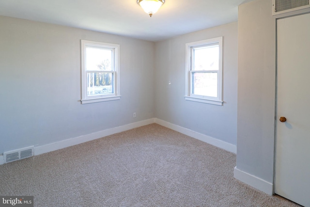 empty room with light colored carpet