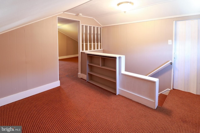 additional living space featuring vaulted ceiling and carpet