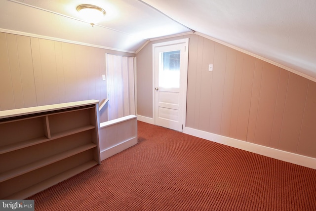 additional living space featuring vaulted ceiling and carpet