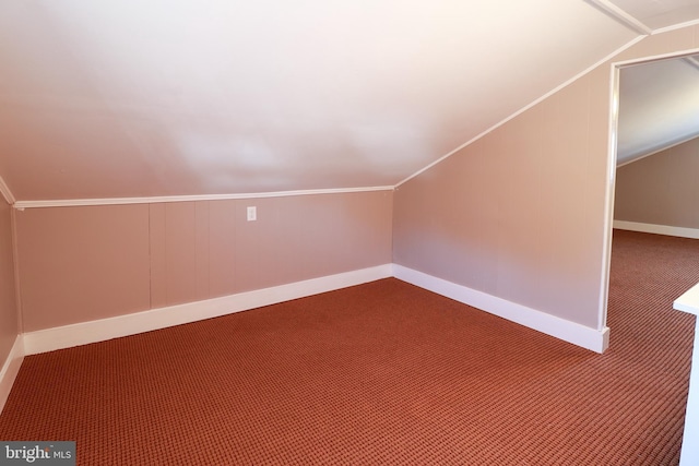 bonus room with lofted ceiling and carpet floors