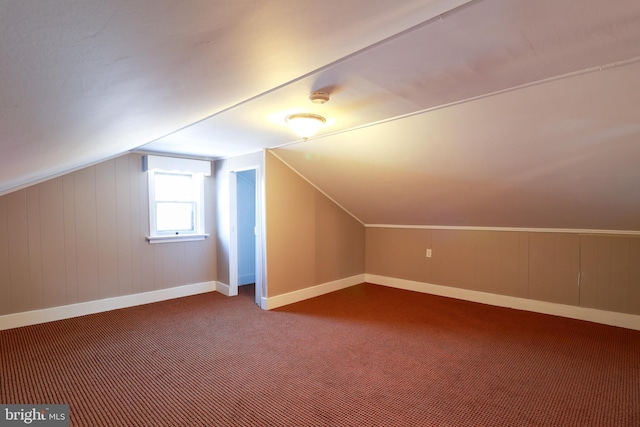 additional living space with lofted ceiling and carpet floors