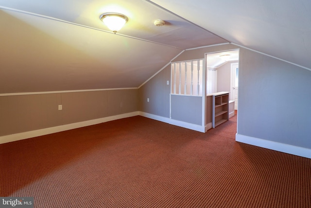 additional living space with lofted ceiling and carpet floors