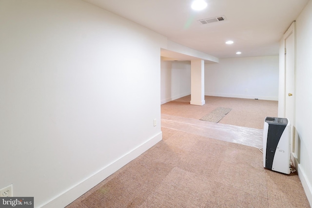 basement featuring light colored carpet