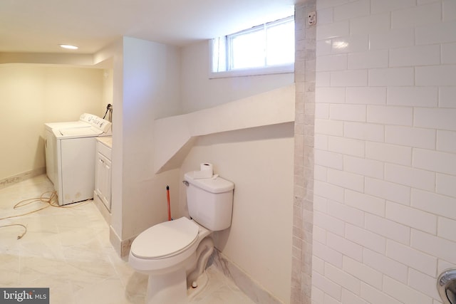 bathroom with toilet and separate washer and dryer