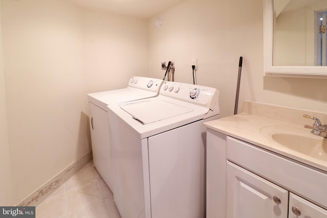 clothes washing area featuring washing machine and dryer and sink