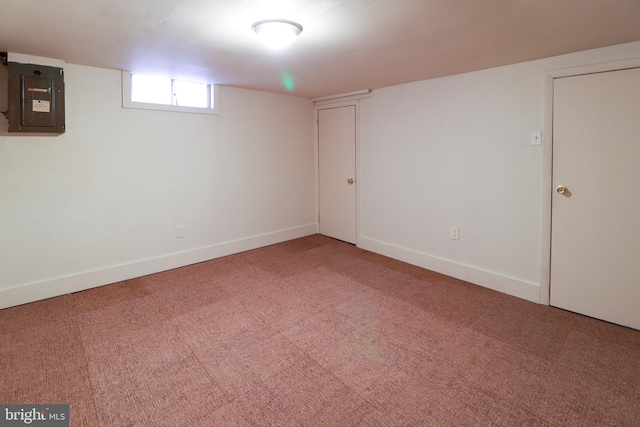 basement with electric panel and carpet