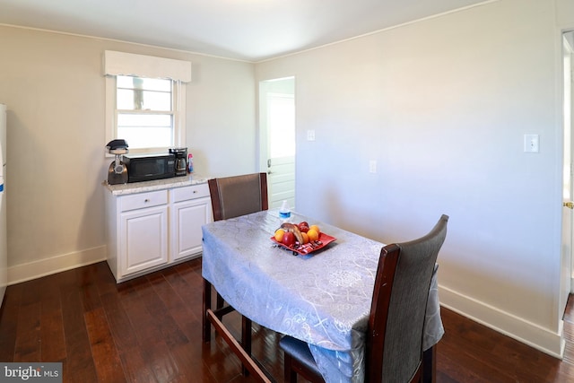 dining area with dark hardwood / wood-style floors