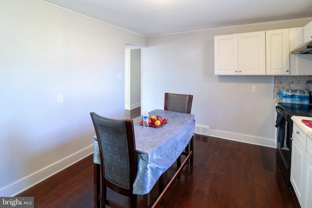 dining space with dark wood-type flooring