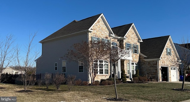 view of front of house with a front yard and a garage